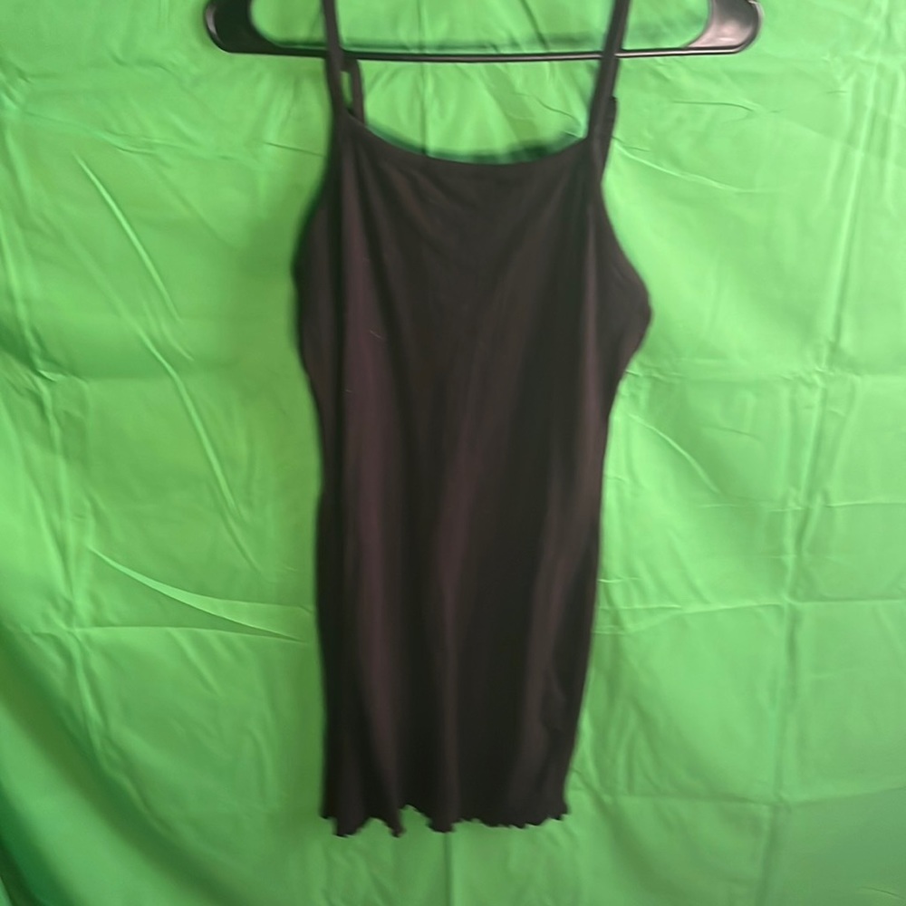 Black form fitting dress with bottom ruffle.